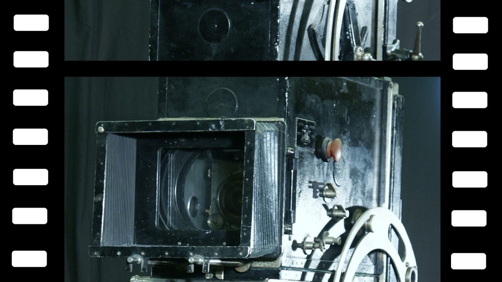 Detalj av en filmremsa, där en filmkamera är avbildad.