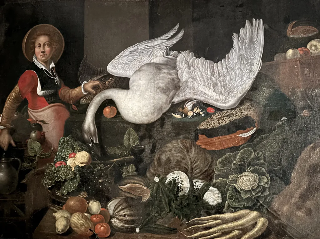 Oljemålning av en kvinna som står bredvid ett bort fullt av matvaror, bland annat en död svan.